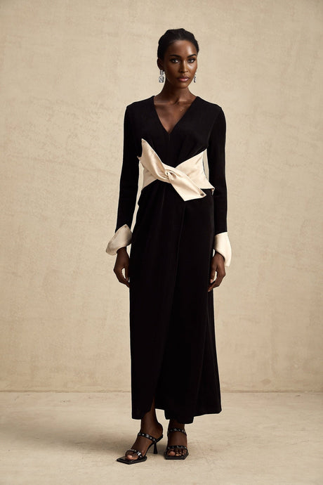 A long maxi dress with a vneck and contrast color bowknot detail featuring a combination of colors and a flowing silhouette
