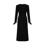 A long maxi dress with a vneck and contrasting colors featuring a bow detail at the neckline