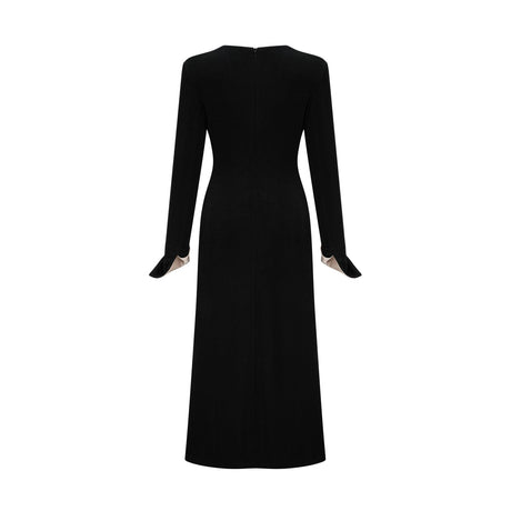A long maxi dress with a vneck and contrasting colors featuring a bow detail at the neckline
