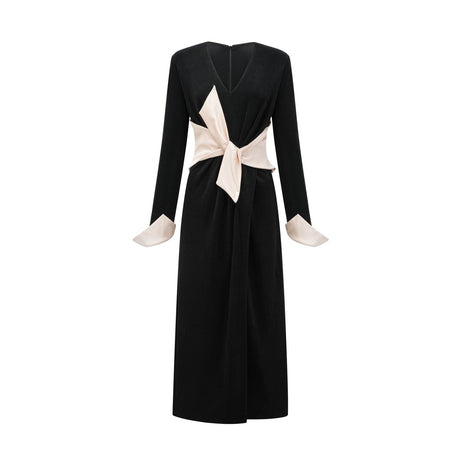 A long maxi dress with a vneck and contrasting colors featuring a prominent bowknot detail at the neckline
