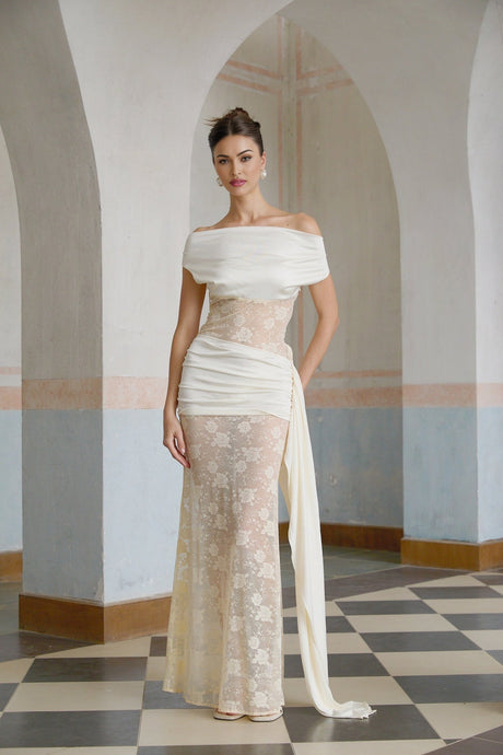 A long maxi dress with floral lace panels and ribbon details in neutral colors featuring a delicate and feminine design
