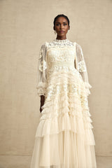 A long maxi dress with layered tulle skirt featuring floral embroidery in a capucine color