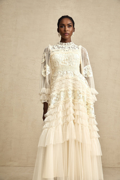 A long maxi dress with layered tulle skirt featuring floral embroidery in a capucine color