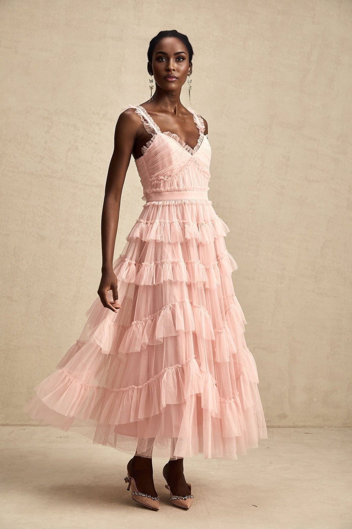 A long maxi dress with multiple layers of ruffled tulle fabric creating a flowing and romantic silhouette