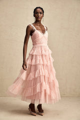 A long maxi dress with multiple layers of ruffled tulle fabric creating a flowing and romantic silhouette