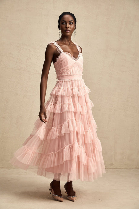 A long maxi dress with multiple layers of ruffled tulle fabric creating a flowing and romantic silhouette