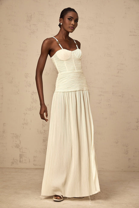 A long neutralcolored maxi dress with side slits and pleated details named Felicie