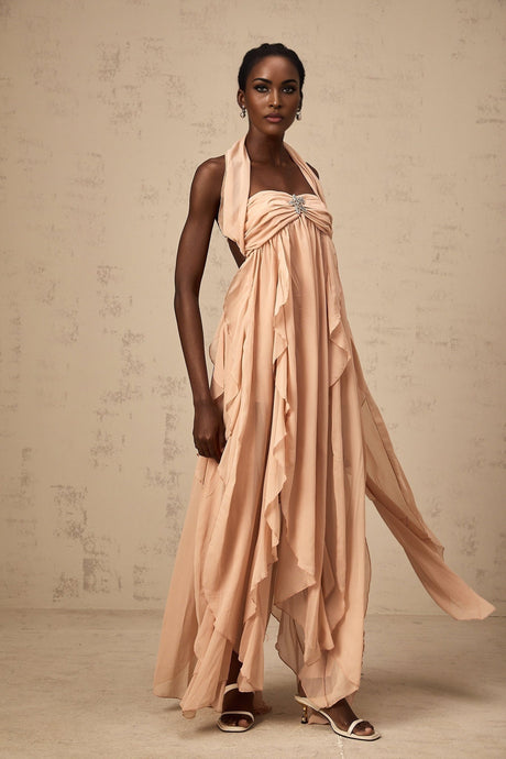 A long pink chiffon maxi dress with a halter neck and ruffle details featuring a flowy silhouette and delicate fabric