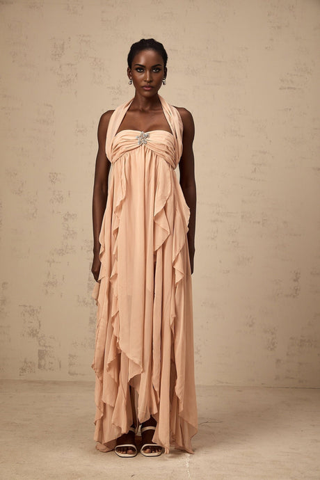 A long pink chiffon maxi dress with a halter neck and ruffle details