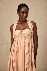 A long pink maxi dress with a halter neck and ruffled chiffon details