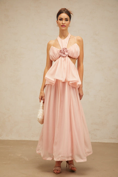 A long pink maxi dress with floral applique details and cut out sections featuring a flowing silhouette and delicate design
