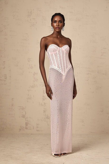 A long pink maxi dress with rhinestone embellishments and a semi sheer design featuring a flowing silhouette and sparkling details throughout