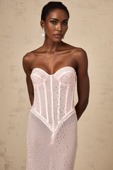 A long pink maxi dress with rhinestone embellishments and semi sheer fabric featuring a flowing silhouette and sparkling details