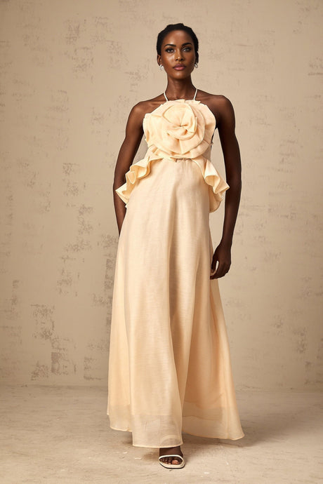 A long pink maxi dress with ruffled 3D petal details throughout creating a layered floral effect