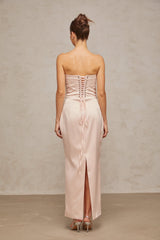 A long pink satin maxi dress with an offshoulder corset style bodice
