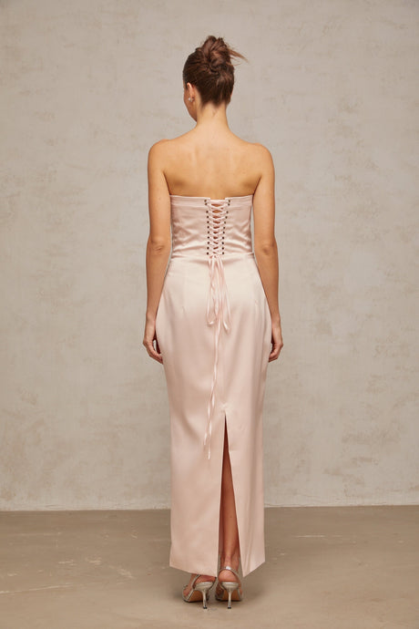 A long pink satin maxi dress with an offshoulder corset style bodice