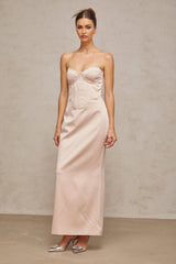 A long pink satin maxi dress with an offshoulder corset style top