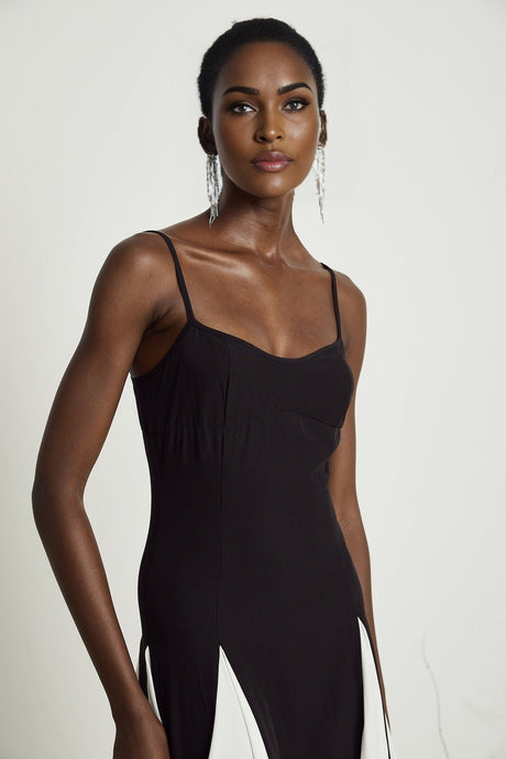 A long plissé maxi dress in contrasting colors named Sofie featuring a flowy pleated design with a mix of light and dark shades