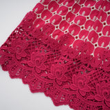 A long red maxi dress with scalloped lace panels featuring a delicate pattern throughout