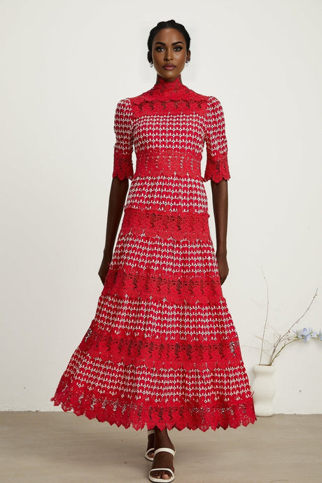 A long red maxi dress with scalloped lace panels featuring a delicate pattern