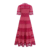 A long red maxi dress with scalloped lace panels featuring a floral pattern The dress has a fitted bodice and flows into a full skirt