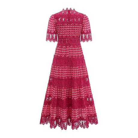A long red maxi dress with scalloped lace panels featuring a floral pattern The dress has a fitted bodice and flows into a full skirt