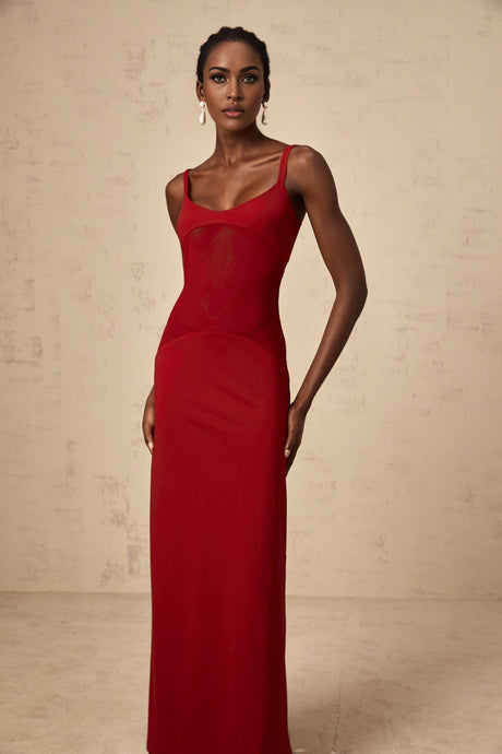 A long red maxi dress with sheer tulle panels designed by Celine