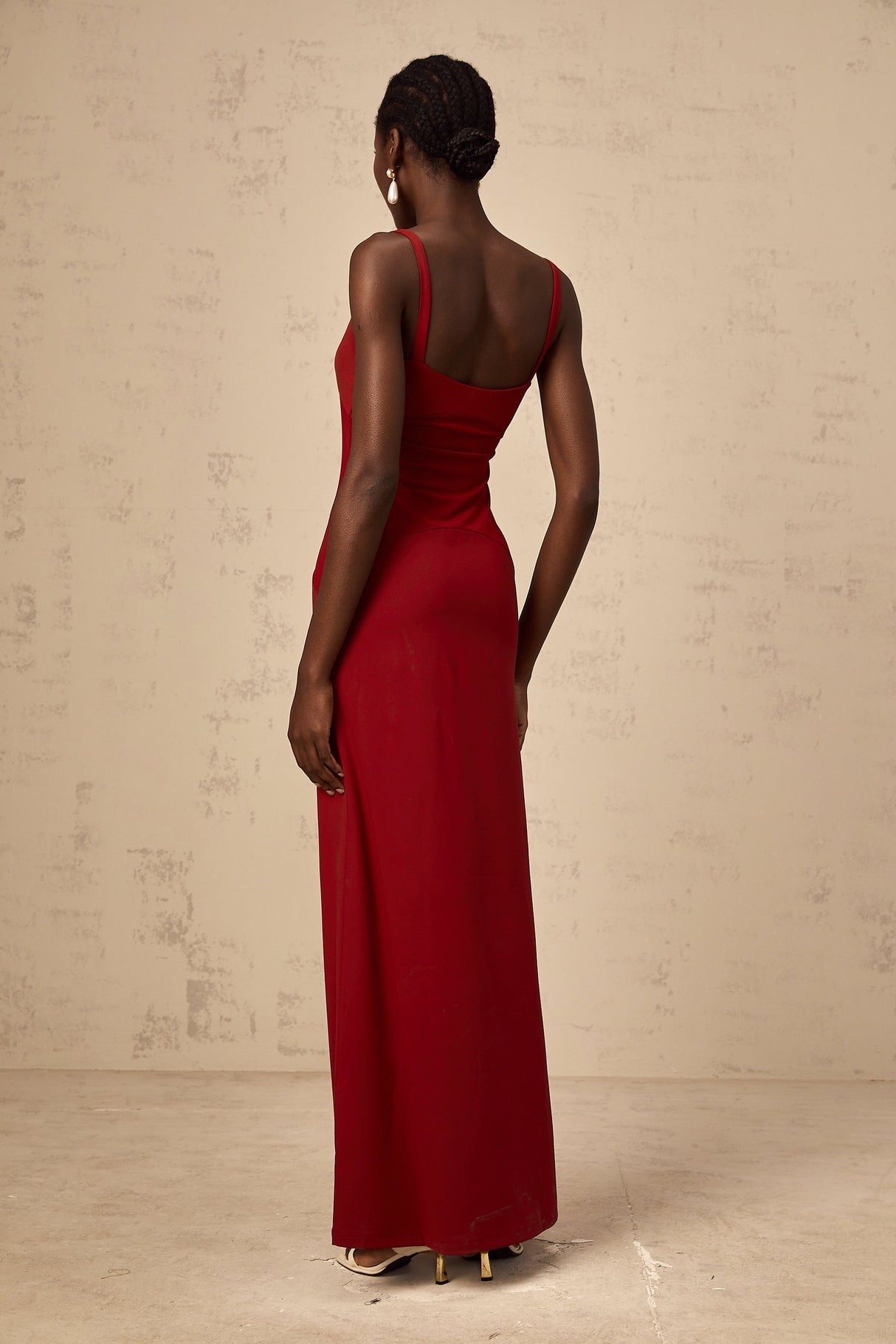 A long red maxi dress with sheer tulle panels designed by Celine