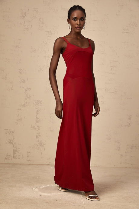 A long red maxi dress with sheer tulle panels made by Celine