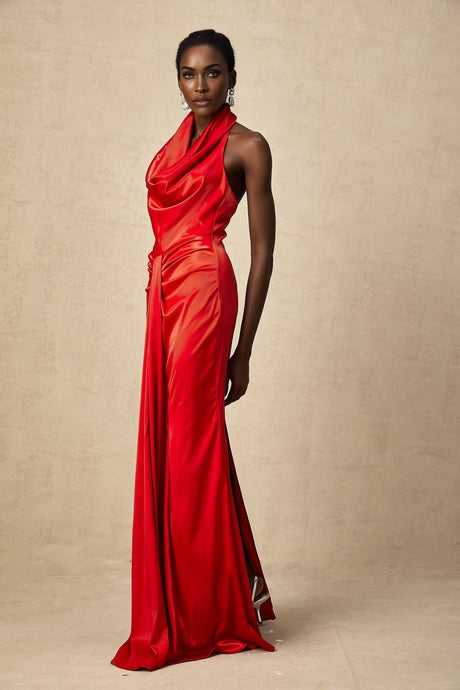 A long red satin maxi dress with a halter neckline and draped design worn by a model