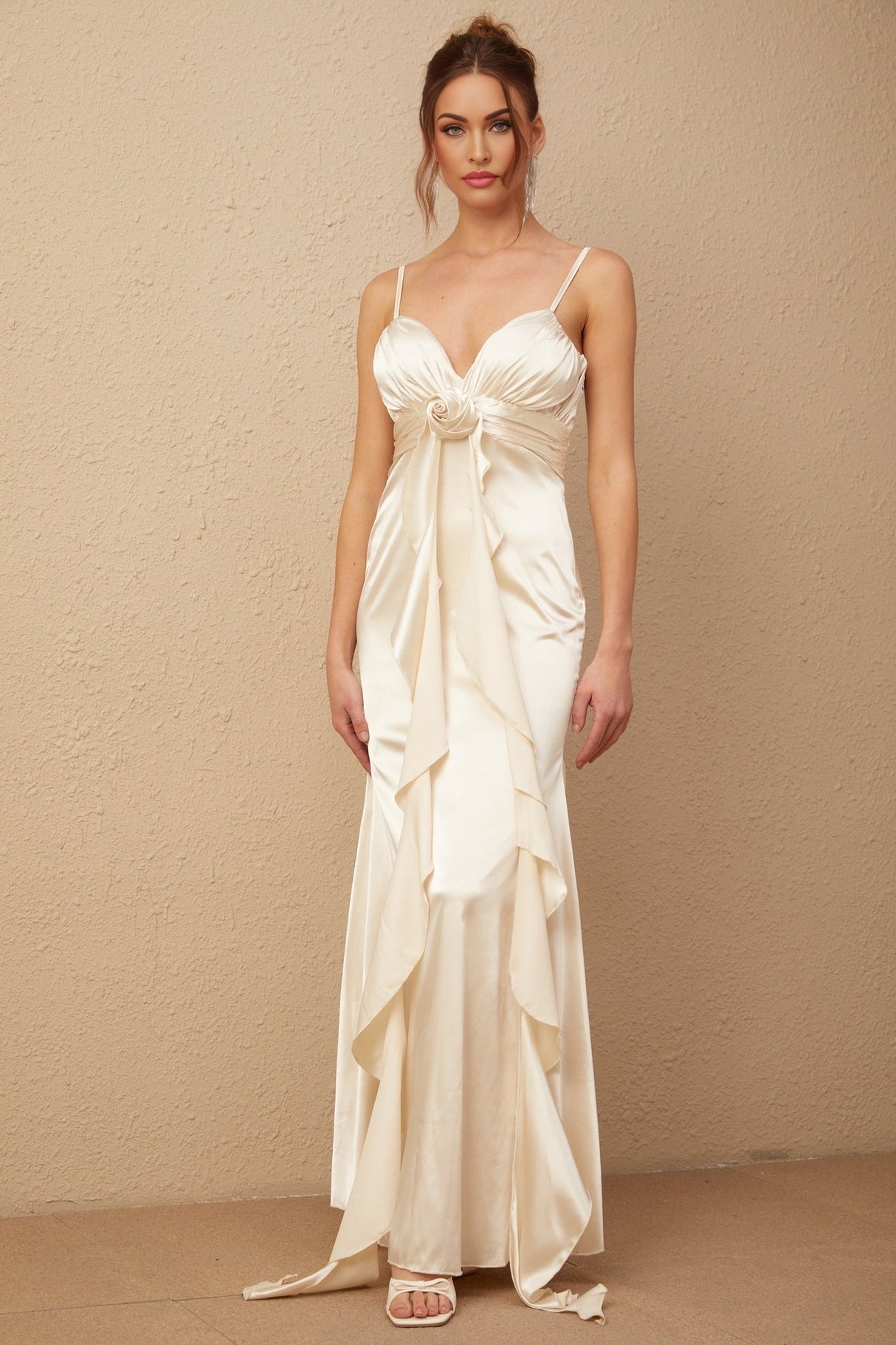 A long satin maxi dress with a corset bodice featuring floral applique details and a flowing skirt in a feminine Filomena style
