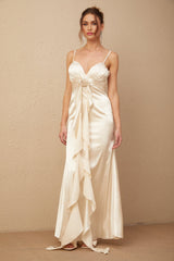 A long satin maxi dress with a corset bodice featuring floral applique details and a flowing skirt