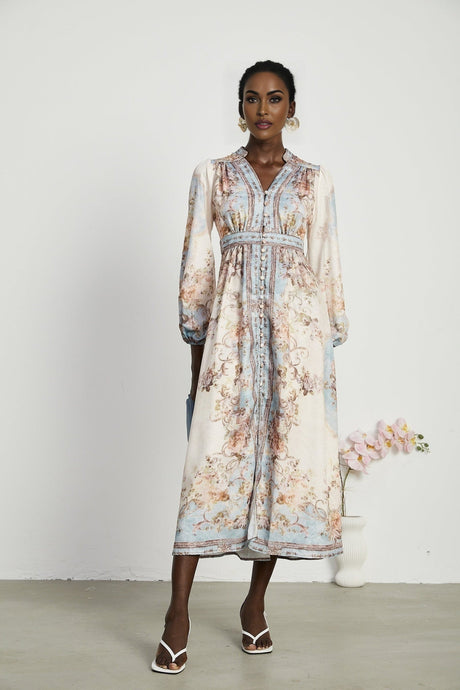 A long sleeve bohemian style dress with a floral print pattern called Camille featuring a flowing silhouette