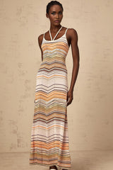A long sleeveless knit dress with vertical multicolored stripes in pastel shades featuring a fitted bodice and flowing maxi skirt