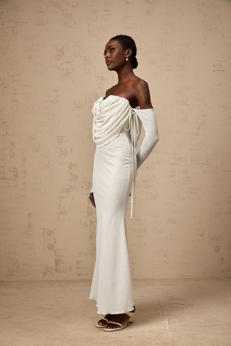 A long strapless maxi dress with a ruched bodice and floral applique details in a soft fabric