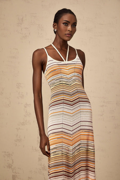 A long striped knit maxi dress from Chloe featuring multiple bright colors in a vertical stripe pattern