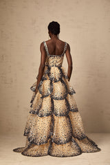 A long tiered maxi dress with sequined petal details and a flowing silhouette