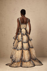 A long tiered maxi dress with sequined petal details and a flowing silhouette