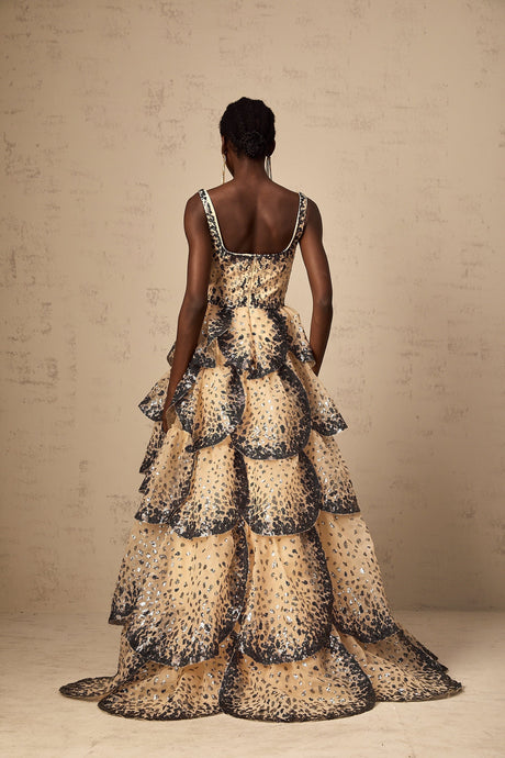 A long tiered maxi dress with sequined petal details and a flowing silhouette