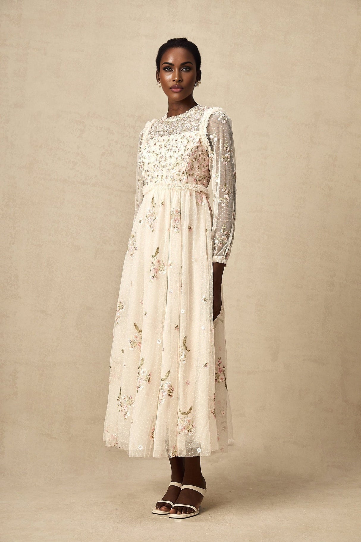 A long tulle midi dress with floral embroidery by Celine featuring delicate floral patterns on sheer fabric and a flowing silhouette