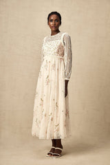 A long tulle midi dress with floral embroidery by Celine featuring delicate floral patterns on sheer fabric and a flowing silhouette