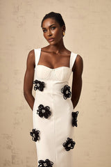 A long white bandage style maxi dress with floral applique details named Olivia