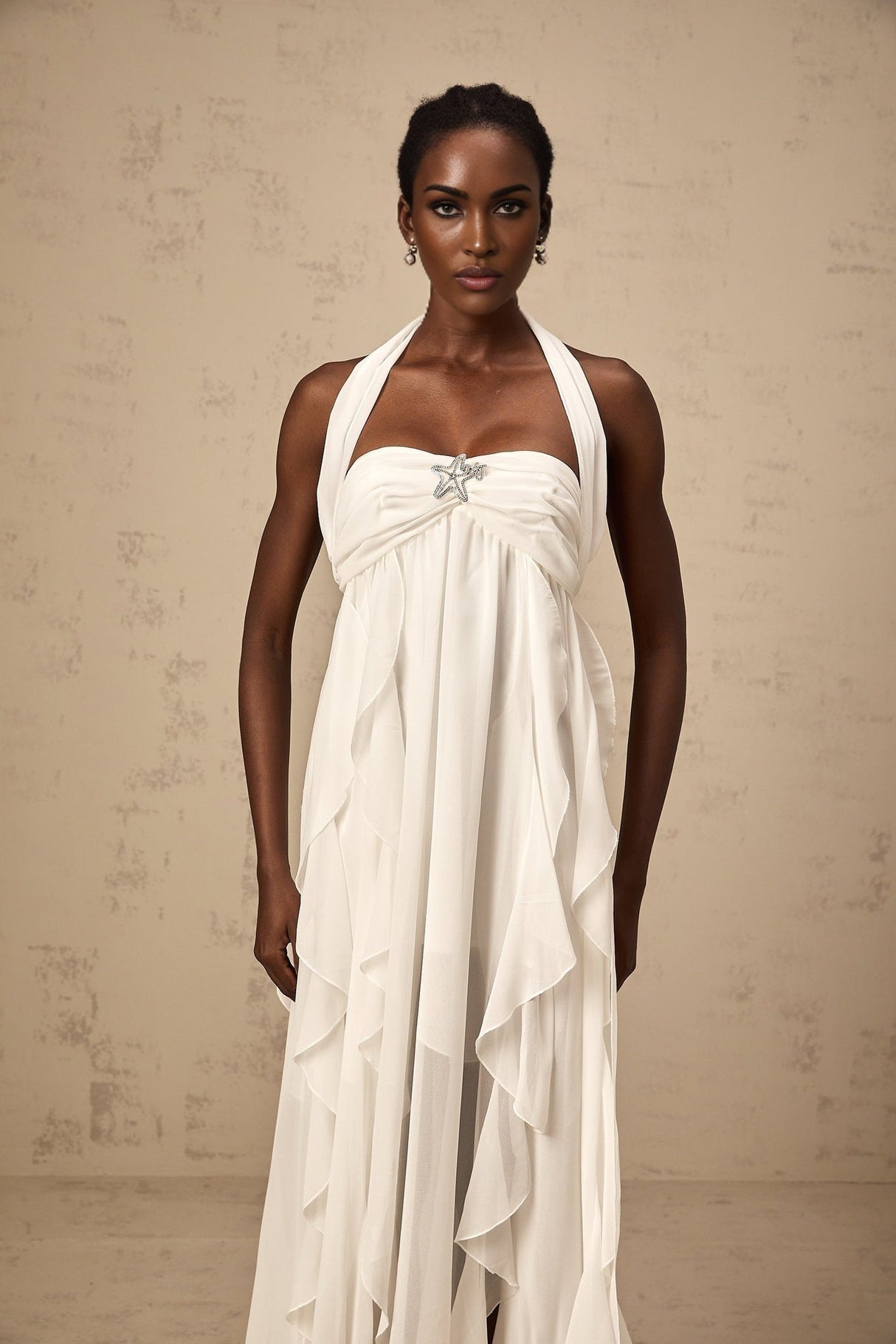 A long white chiffon maxi dress with a halter neck and ruffle details named Mariah