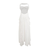 A long white chiffon maxi dress with a halter neckline and ruffled details worn by a model against a plain background