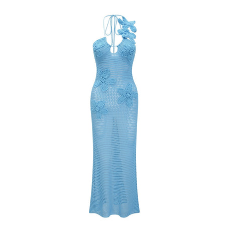 A long white crochet maxi dress with colorful faux flower embellishments scattered throughout the design