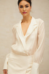 A long white flowy maxi dress with sheer panels and a relaxed fit