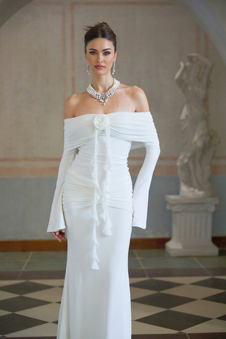 A long white knit maxi dress with glittery floral appliques scattered across the fabric named Wanda