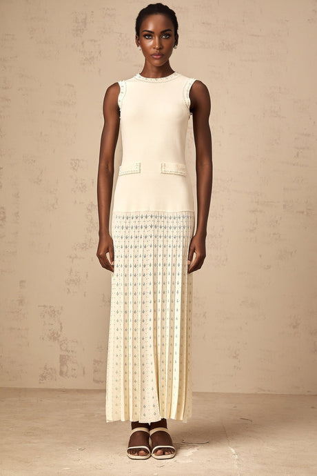 A long white knitted maxi dress with faux pearl embellishments