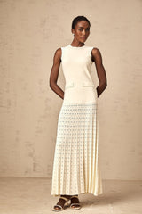 A long white knitted maxi dress with faux pearl embellishments