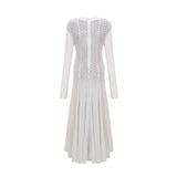 A long white lace maxi dress with a wavy pattern design featuring a feminine silhouette and delicate details